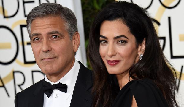Actor George Clooney and his wife Amal Clooney.  This image is when they arrive on the red carpet for the 72nd annual Golden Globe Awards on January 11, 2015 at the Beverly Hilton (Photo: Mark Ralston / AFP)
