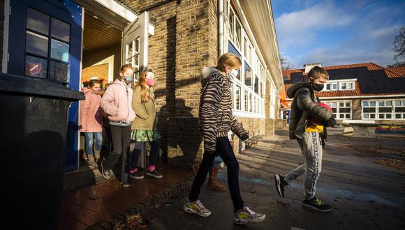 Los alumnos llegan para asistir a una lección en una escuela primaria en De Bilt, mientras Países Bajos endurece las medidas de salud. (Foto: Jeroen JUMELET / AFP)
